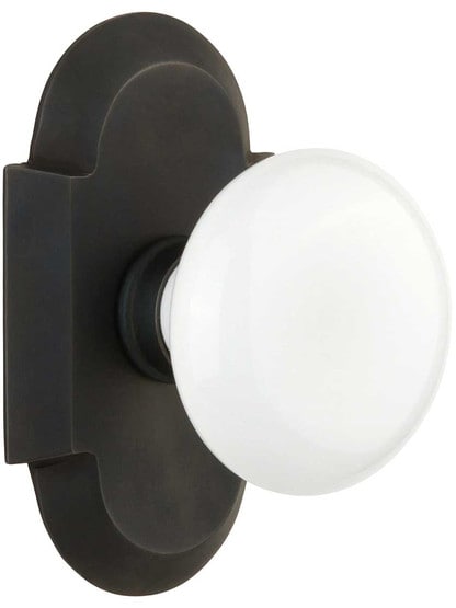 Arched Rosette Door Set with White Porcelain Knobs in Oil-Rubbed Bronze.